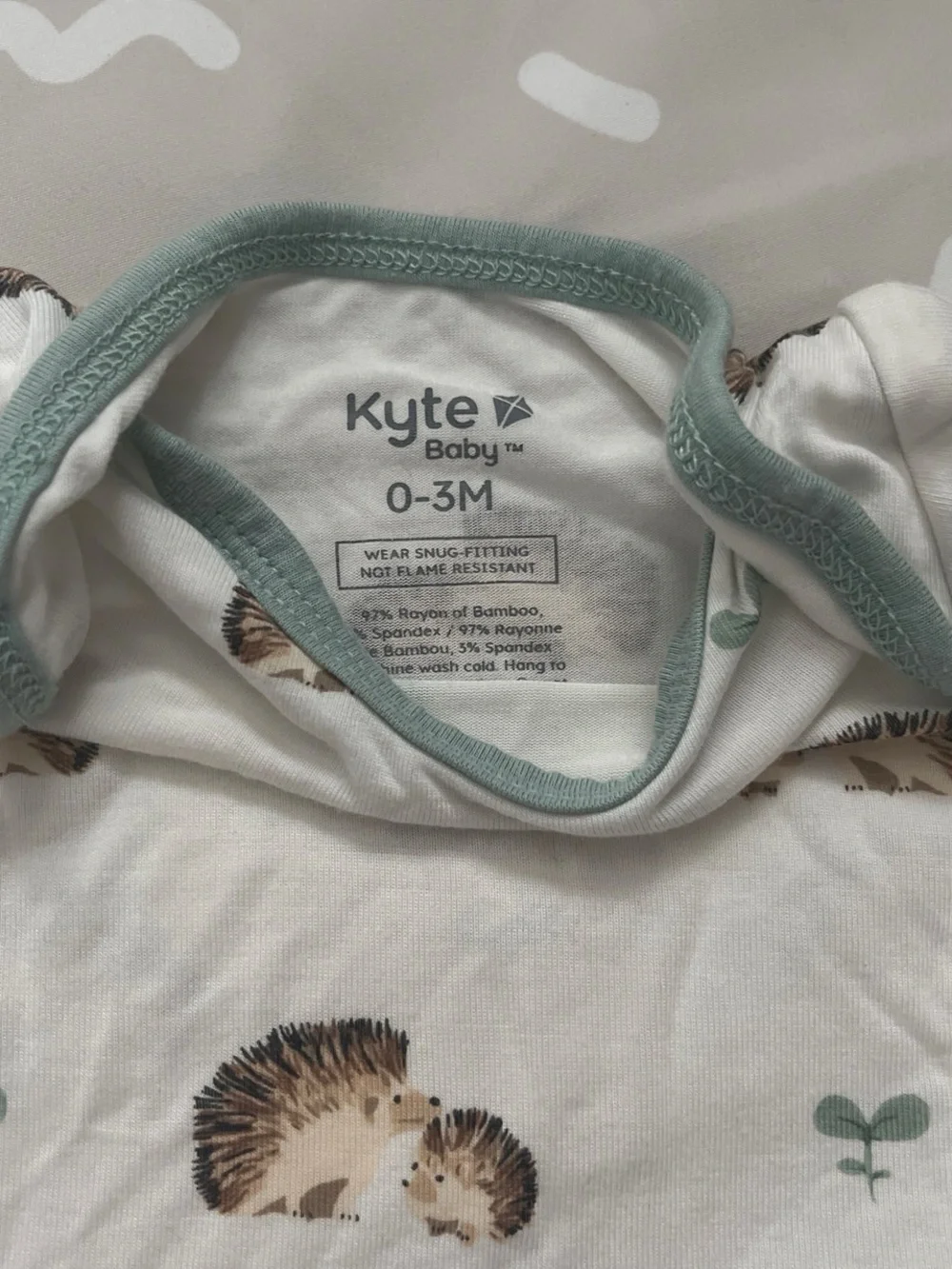 Kyte BABY White Bodysuit with Hedgehog Print and Sage Trim